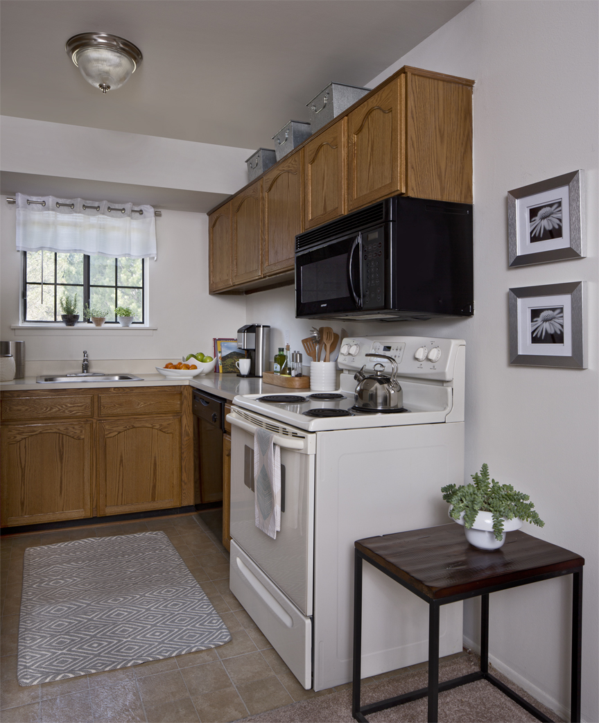 Kitchen with stove, microwave, and sink