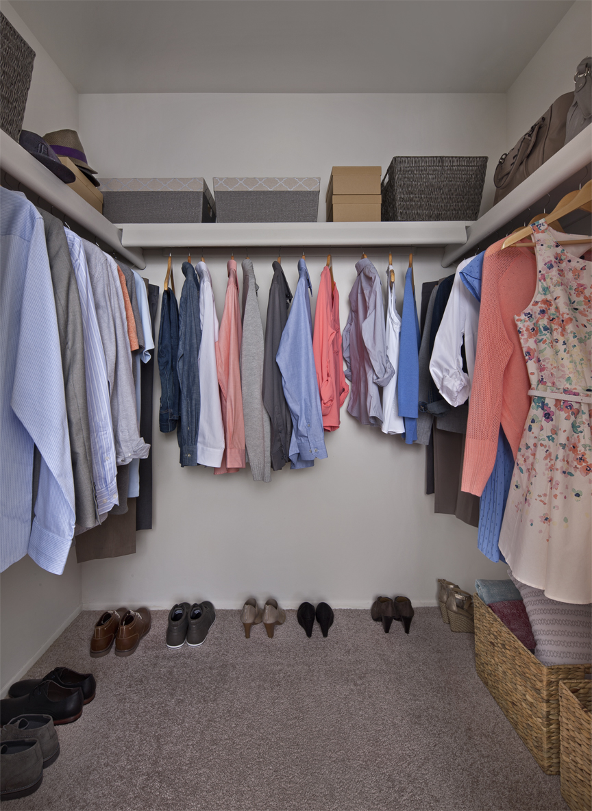 Walk-in closet with lots of clothes