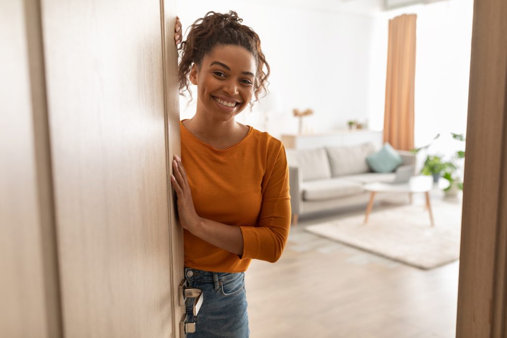 A young woman welcomes you to her Livonia apartment.